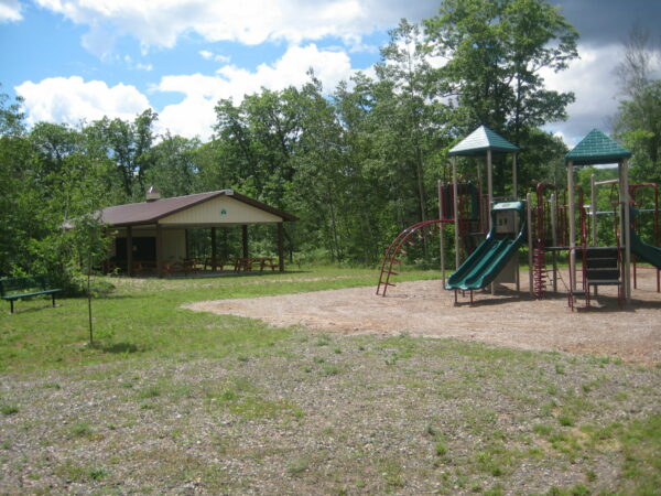 Playground and picnic shelter in a park.